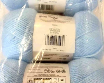 May include: A package of three skeins of light blue Bernat yarn made of 100% acrylic. Each skein weighs 5 ounces and measures 362 yards. The packaging includes care instructions, a barcode, and a label indicating the color as pale blue.