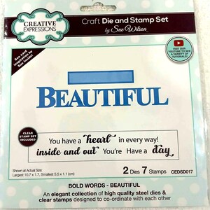 May include: A Creative Expressions craft die and stamp set by Sue Wilson featuring the word BEAUTIFUL in a blue die-cut font. The set includes clear stamps with the phrases You have a heart in every way, inside and out, You're, and Have a day. Includes 2 dies and 7 stamps with dimensions of 10.7 x 1.7 cm and 5.5 x 1.1 cm.