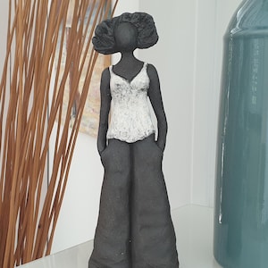 ceramic sculpture woman standing black earth white top
