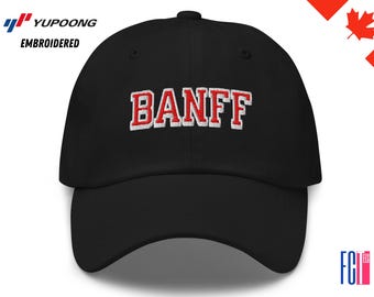 May include: Black baseball cap with the word "BANFF" embroidered in red with a white outline. The cap has a curved brim and a fabric strap closure. The cap is a classic style.