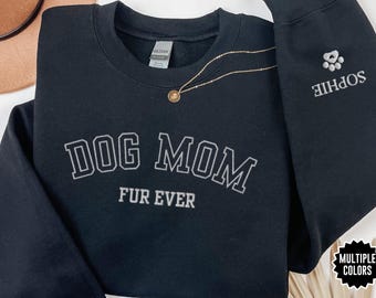 May include: Black sweatshirt with the text "Dog Mom Fur Ever" in white lettering. The right sleeve has a small paw print and the text "Sophie" in white lettering.