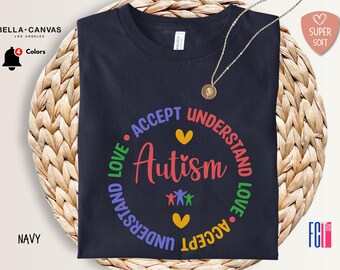 May include: A navy blue t-shirt with a circle graphic that says "Accept Understand Love Autism Understand Love Accept". The graphic features a rainbow of colors and a heart in the center.