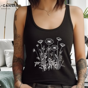 May include: A black tank top featuring a white outline of a bouquet of flowers. The tank top has the text "BELLA+CANVAS LOS ANGELES" at the top.