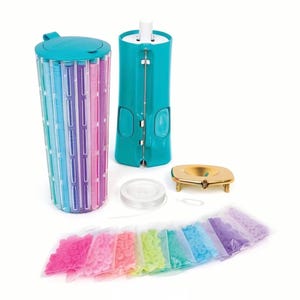 May include: A craft kit with a teal bead spinner, a multi-colored bead storage container, and a gold-colored tray. The kit includes clear string, a metal needle, and several bags of colorful beads in shades of pink, orange, green, blue, and purple.
