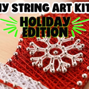 May include: A DIY string art kit featuring a mitten-shaped wooden board with red and white string wrapped around silver nails to form a snowflake pattern. The text DIY STRING ART KITS HOLIDAY EDITION is displayed in bold black letters.