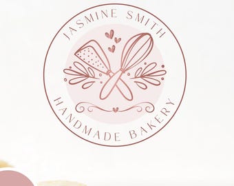 May include: A circular logo design in shades of pink and brown, featuring the text "Jasmine Smith Handmade Bakery." The logo includes illustrations of a whisk, a knife, and decorative floral elements. The bottom of the image has the text "DIY - EDITABLE LOGO".