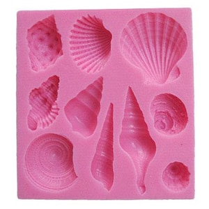 May include: Pink silicone mould with 10 different seashell shapes. The mould is designed for making edible decorations for cakes and other desserts.