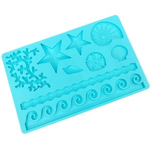May include: A turquoise silicone mould featuring various marine-themed designs. The mould includes starfish, seashells, coral, and wave patterns. The designs are raised and detailed, ideal for creating decorative elements.