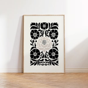 May include: Black and white floral print with a large, light gray flower in the center. The print is framed in a simple wooden frame.