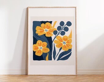 May include: A framed print featuring a minimalist floral design. The print depicts yellow flowers with blue centres and dark blue leaves on a cream background.