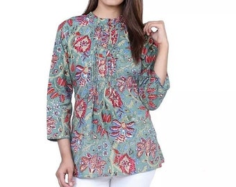 May include: A green floral print top with a mandarin collar and a button closure. The top has a pleated front and three-quarter sleeves.