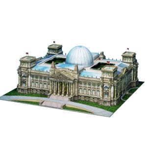 May include: A detailed model of a building with a large dome and multiple towers. The structure features columns, windows, and flags, set on a green base. The color palette includes shades of beige, gray, and blue.