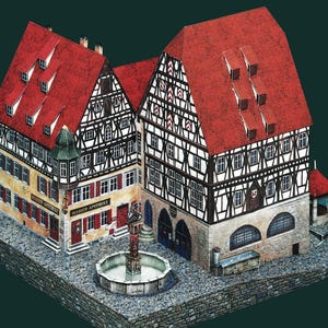 Puede incluir: Maqueta arquitectónica detallada de una plaza europea con varios edificios con tejados de tejas rojas, paredes de entramado de madera y una fuente central. Los edificios tienen múltiples ventanas y puertas, con el texto "MARIEN-APOTHEKE" visible.