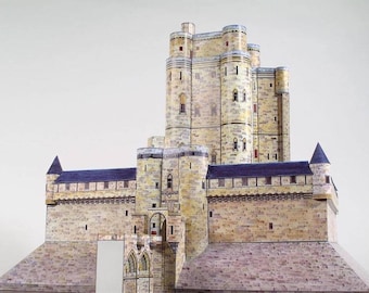 May include: A detailed model of a stone castle with a tall central tower and multiple smaller towers. The castle is made of light brown stone with dark grey accents and a slate roof.