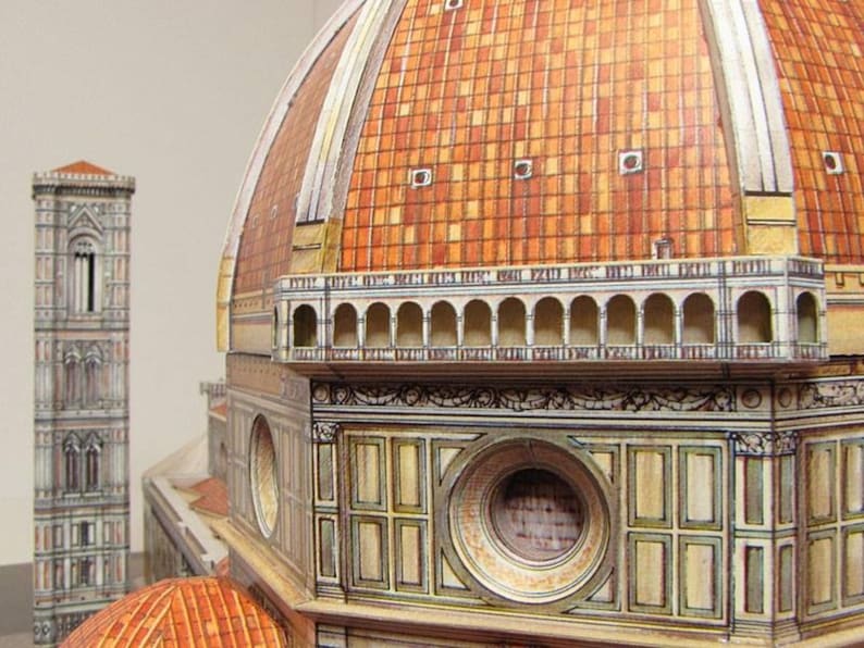 May include: A detailed model of the dome of the Florence Duomo, a famous Italian cathedral. The model is made of paper and features intricate details, including the dome's terracotta tiles, the lantern at the top, and the surrounding arches.