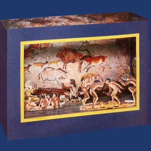 May include: A diorama showing a prehistoric cave painting scene. The artwork features figures of early humans and various animals in shades of brown, orange, and white, set within a blue and yellow framed box.