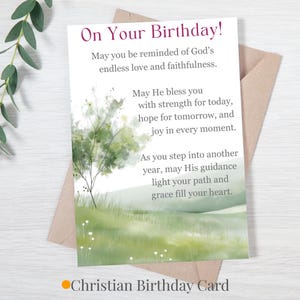 May include: A birthday card with the text "On Your Birthday!" in a purple script. The card features a watercolor painting of a tree and grassy field. The text "Christian Birthday Card" is at the bottom.