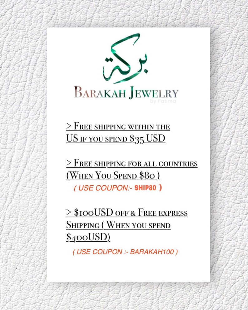 May include: A white card with the text "BARAKAH JEWELRY" and Arabic script above it. The card lists free shipping offers for purchases of $35, $80, and $400 USD, with associated coupon codes.
