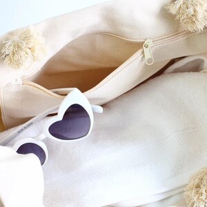 a white bag with a pair of sunglasses in it