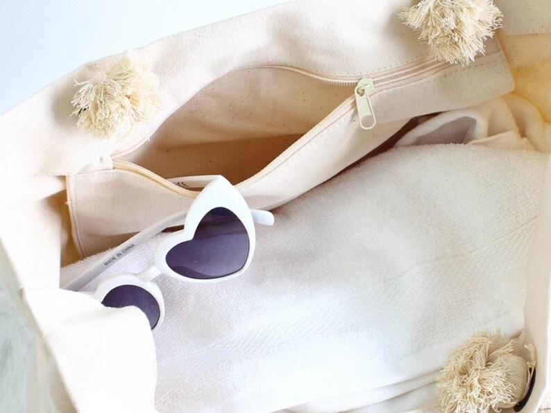 a white bag with a pair of sunglasses in it