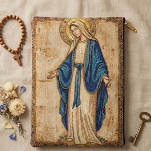 May include: A rectangular tapestry pouch depicting a religious figure in blue and white robes with a gold halo. A wooden rosary, dried flowers, and a vintage key are also present. The pouch has a gold zip and a decorative border.