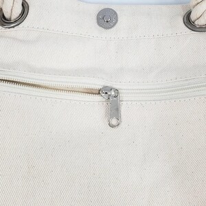 a close up of a person's pants with zippers