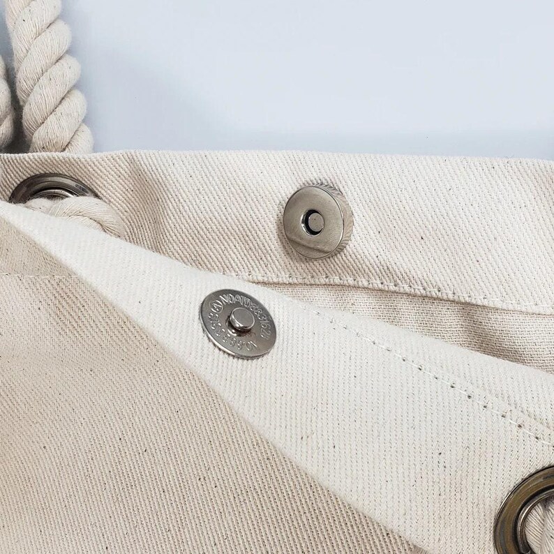 a close up of a white cloth with buttons