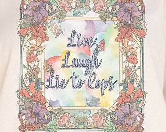 May include: A white t-shirt featuring a floral design and the text "Live Laugh Lie to Cops" in a colourful font.
