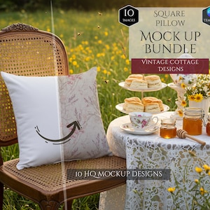 May include: A square pillow mock-up with a vintage cottage design, displayed on a wicker chair. The pillow has a white side and a floral pattern side. A table with tea, honey, and scones is set in a field of yellow flowers.