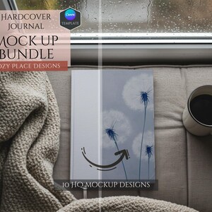 May include: A hardcover journal mockup with a dandelion design on the cover. The journal is sitting on a gray couch with a blanket and a cup of coffee. The text "10 HQ MOCKUP DESIGNS" is printed on the bottom of the journal.