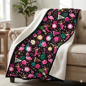 May include: A black throw blanket with a white sherpa lining featuring a repeating pattern of pink flamingos, monkeys in baseball uniforms, baseballs, tropical hibiscus flowers, green palm leaves, and pennants with the text Party Animals.