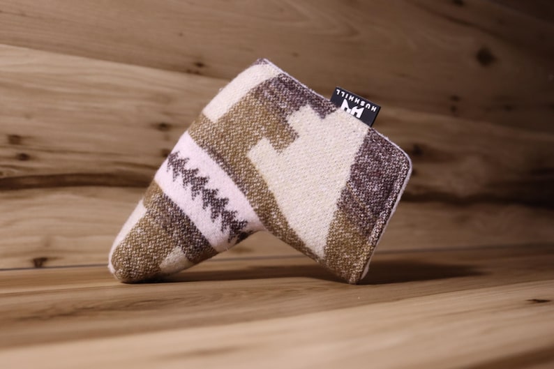 Op de afbeelding: Een golfclubhoofdbeschermer met een geometrisch patroon in tinten bruin, cr&egrave;me en paars. De hoes heeft een rechthoekig label met de merknaam "HUSHHILL". De hoes is gemaakt van een geweven stof.