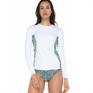 May include: White long-sleeve rash guard with a paisley pattern on the sides. The rash guard is made of a lightweight, quick-drying fabric and is perfect for swimming, surfing, or other water sports.