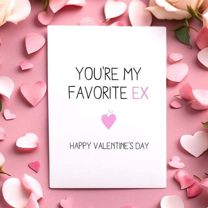 May include: A white greeting card with the text "YOU'RE MY FAVORITE EX" and "HAPPY VALENTINE'S DAY" on a pink background. The card features a pink heart graphic and is surrounded by pink heart-shaped decorations and rose petals.