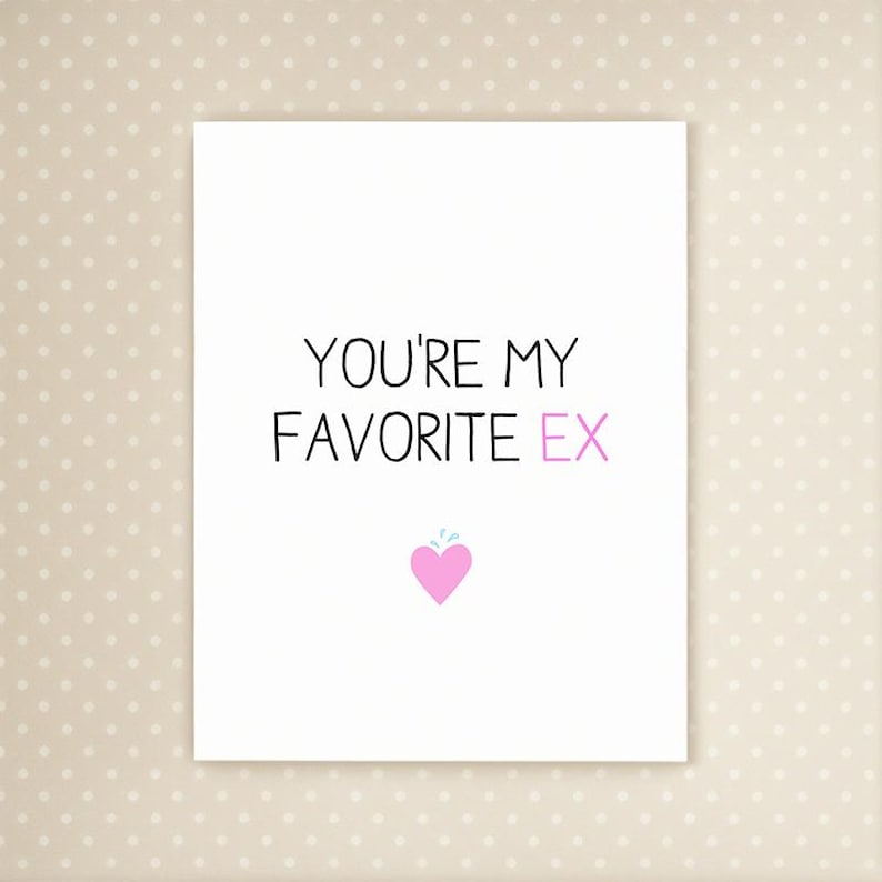 May include: A white greeting card with the text "YOU'RE MY FAVORITE EX" in black and pink. A pink heart with a small blue splash is at the bottom. The card is on a dotted background.
