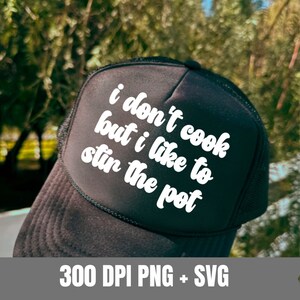 Könnte beinhalten: Schwarze Trucker-Kappe mit weißem Text, der "Ich koche nicht, aber ich mag es, den Topf zu rühren" lautet.