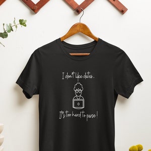 May include: Black t-shirt with a white graphic that says "I don't like dates... It's too hard to parse!" and a cartoon of a person with glasses and a computer screen.