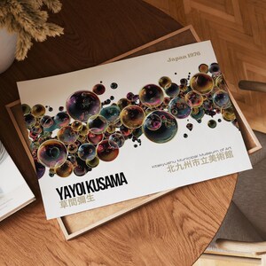 May include: A print featuring a colorful bubble design by Yayoi Kusama. The artwork includes the text "Japan 1976", "YAYOI KUSAMA", and the name of the Kitakyushu Municipal Museum of Art in both English and Japanese.