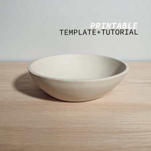 Può includere: Una ciotola di cemento bianco su una superficie di legno marrone chiaro. Il testo "PRINTABLE TEMPLATE+TUTORIAL" è sopra la ciotola.