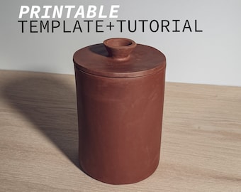 May include: A terracotta-colored ceramic jar with a lid and a rounded top. The jar is sitting on a wooden surface. The text "PRINTABLE TEMPLATE + TUTORIAL" is visible above the jar.