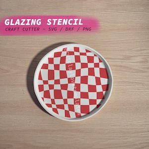 May include: A white round plate with a red and white checkered pattern. The plate is on a wooden surface. The text "GLAZING STENCIL" is at the top of the image. The text "CRAFT CUTTER ~ SVG / DXF / PNG" is below the first line of text.