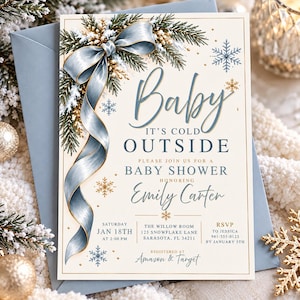 May include: A cream-colored baby shower invitation card featuring a blue ribbon, pine branches, and gold snowflakes. The text reads: Baby IT'S COLD OUTSIDE, PLEASE JOIN US FOR A BABY SHOWER HONORING Emily Carter, SATURDAY JAN 18TH AT 2:00 PM, THE WILLOW ROOM 123 SNOWFLAKE LANE SARASOTA, FL 34211, RSVP TO JESSICA 941-555-0123 BY JANUARY 5TH, REGISTERED AT Amazon & Target.