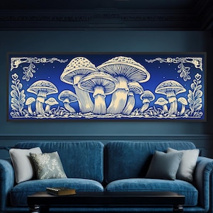 May include: A framed art piece featuring a cluster of stylized mushrooms in shades of cream and off-white against a deep blue background. The artwork has a detailed, engraved appearance, with decorative floral elements along the top and bottom edges. The piece is displayed above a blue sofa.