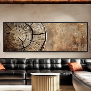 May include: A panoramic wall art print featuring a close-up of a tree trunk cross-section with visible growth rings. The wood is a warm brown colour with a natural, rustic texture. The background is a light brown with a subtle distressed effect.