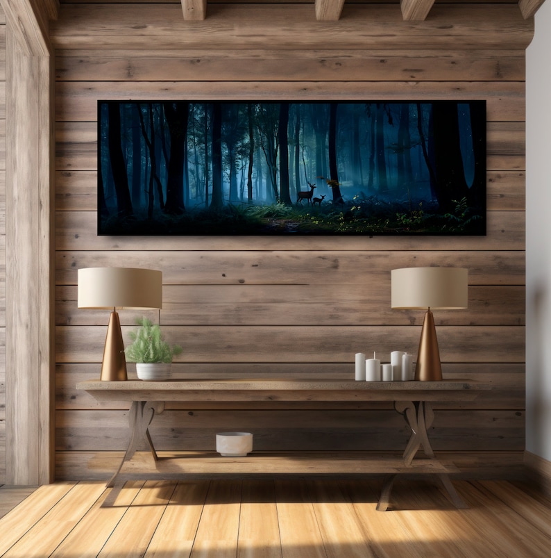 May include: A long, rectangular canvas print depicting a serene forest scene with deer. The artwork features a dark, misty forest with tall trees and a soft, blue-green color palette. The print is displayed above a wooden console table.