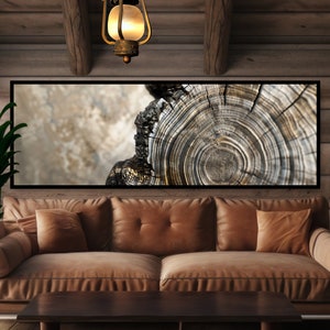 May include: A close-up of a tree trunk cross-section, showing the intricate rings of growth. The wood is a mix of light and dark brown, with a natural, rustic texture. The image is framed and displayed on a wall above a brown leather couch.