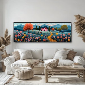 May include: A framed painting of a pink house with a yellow path leading to it, surrounded by colorful flowers and trees in a field with mountains in the background.