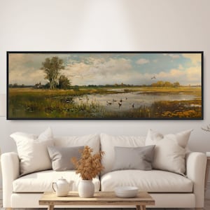 May include: A panoramic landscape painting depicting a tranquil lake with a small group of ducks swimming in the water. The lake is surrounded by lush green vegetation and trees, with a distant farmhouse visible in the background. The sky is a soft blue with fluffy white clouds.