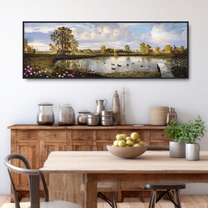 May include: A panoramic landscape painting depicting a serene lake with ducks swimming in the water. The lake is surrounded by lush green trees and a wooden dock extends into the water. The sky is a bright blue with fluffy white clouds.