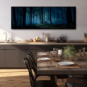 May include: A long, rectangular canvas print depicting a dark, misty forest scene. Tall, silhouetted trees frame a path leading to a bright, ethereal clearing. Two deer stand near the light. The artwork is displayed above a kitchen counter and dining table.